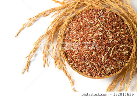 Organic Brown Rice in Basket with Golden Rice Ears on White Background Organic Brown Rice in Basket with Golden Rice Ears on White Background 132915639