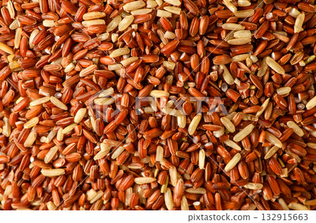 Close up pile of uncooked raw brown red rice or beras merah food ingredients Close up pile of uncooked raw brown red rice or beras merah food ingredients 132915663