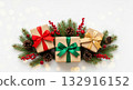 Christmas gifts wrapped in craft paper with red, green, and gold ribbons on a white background with bokeh. 132916152