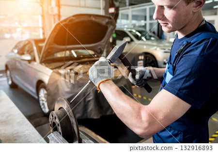 Car mechanic repair car brakes at service station. Car repair service 132916893