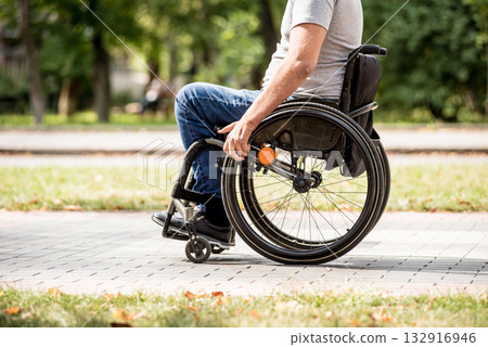 Handicapped man in wheelchair walk at the park alley Handicapped man in wheelchair walk at the park alley 132916946