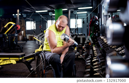 Disabled man training in the gym of rehabilitation center 132917000