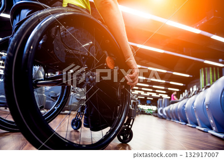 Disabled man training in the gym of rehabilitation center 132917007