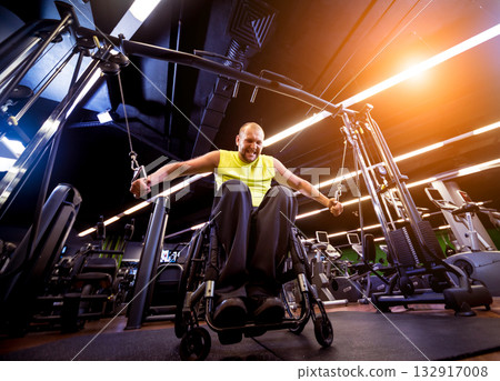 Disabled man training in the gym of rehabilitation center 132917008