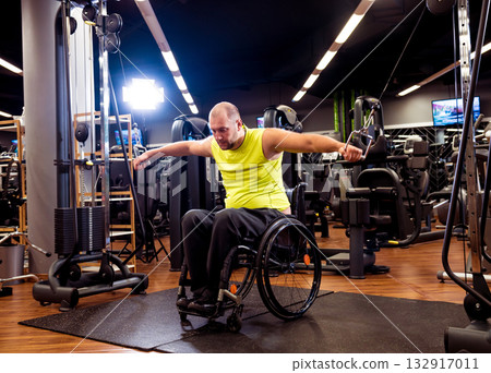 Disabled man training in the gym of rehabilitation center 132917011