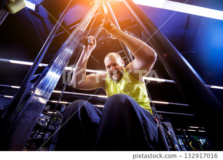 Disabled man training in the gym of rehabilitation center 132917016