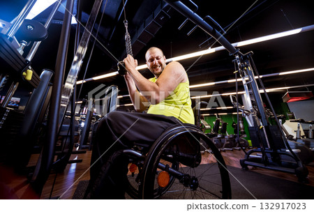Disabled man training in the gym of rehabilitation center Disabled man training in the gym of rehabilitation center 132917023