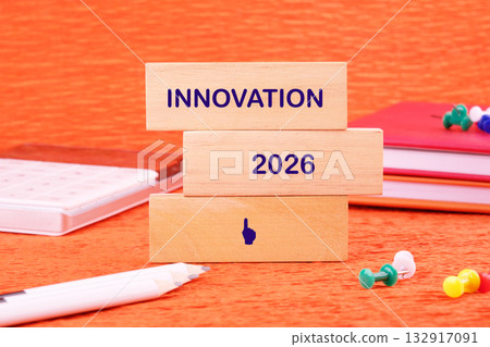 Blocks displaying the words innovation and 2026 sit on a vibrant orange surface surrounded by stationery, symbolizing future creativity and ideas for progress in various industries Blocks displaying the words innovation and 2026 sit on a vibrant orange surface surrounded by stationery, symbolizing future creativity and ideas for progress in various industries 132917091