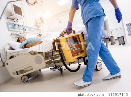 Doctors give resuscitation to a male patient in the emergency room. 132917143