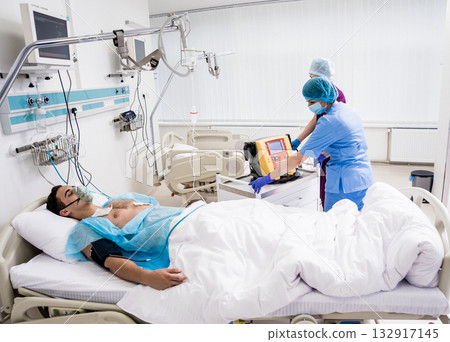 Doctors give resuscitation to a male patient in the emergency room. Doctors give resuscitation to a male patient in the emergency room. 132917145