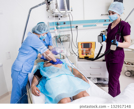 Doctors give resuscitation to a male patient in the emergency room. Doctors give resuscitation to a male patient in the emergency room. 132917148