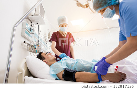 Doctors give resuscitation to a male patient in the emergency room. Doctors give resuscitation to a male patient in the emergency room. 132917156