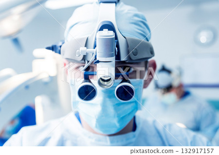 Portrait of spinal surgeon in operating room with surgery equipment. 132917157