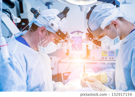 Spinal surgery. Group of surgeons in operating room with surgery equipment.  132917159