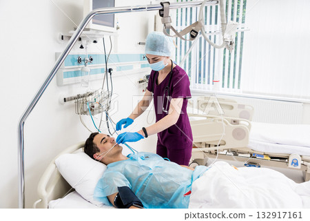 Doctors give resuscitation to a male patient in the emergency room. 132917161