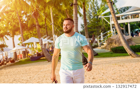 Young man on a tropical beach. Summer 132917472