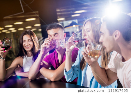 Cheerful friends in the pub. Drinking beer, wine and whisky Cheerful friends in the pub. Drinking beer, wine and whisky 132917495