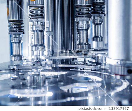 Automatic filling machine pours water into plastic PET bottles. Automatic filling machine pours water into plastic PET bottles. 132917527