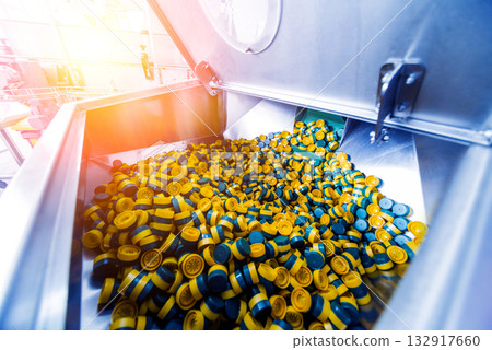 Automatic filling machine pours water into plastic PET bottles. Automatic filling machine pours water into plastic PET bottles. 132917660
