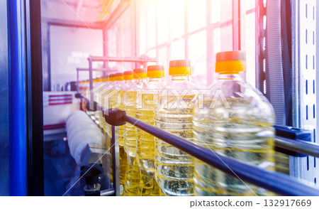 Bottling line of sunflower oil in bottles. Vegetable oil production plant 132917669