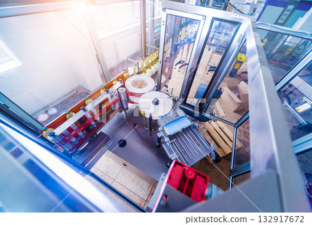 Automatic labeling machine during operation. Factory for the production Automatic labeling machine during operation. Factory for the production 132917672
