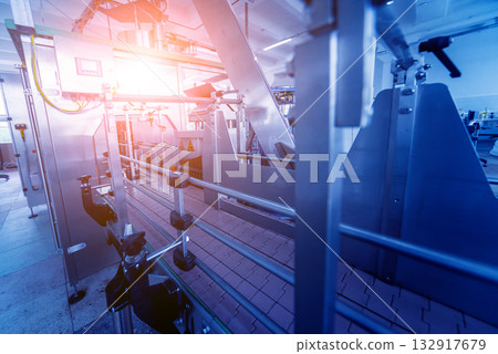 Bottling line of sunflower oil in bottles. Vegetable oil production plant.  132917679