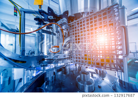 Automatic filling machine pours water into plastic PET bottles. Automatic filling machine pours water into plastic PET bottles. 132917687