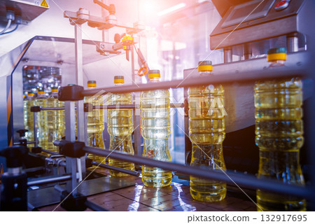 Bottling line of sunflower oil in bottles. Vegetable oil production plant.  132917695