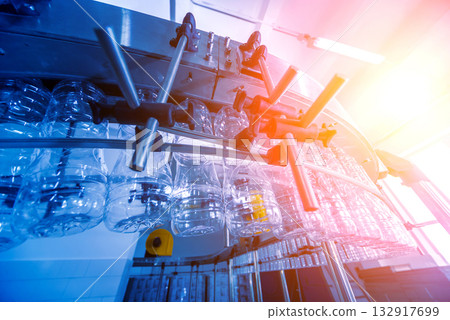 Bottling line of sunflower oil in bottles. Vegetable oil production plant. Bottling line of sunflower oil in bottles. Vegetable oil production plant. 132917699
