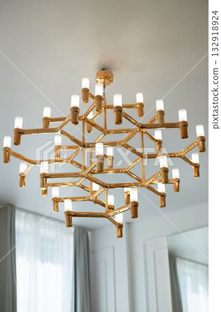 A golden chandelier with many light bulbs. Style, minimalism and luxury, 132918924