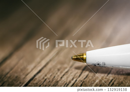 Close-up of a ballpoint pen lying on a table 132919138