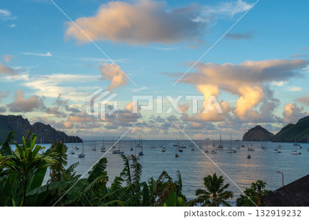 Taiohae Bay at sunset with sailboats in Nuku Hiva, Marquesas Islands, French Polynesia Taiohae Bay at sunset with sailboats in Nuku Hiva, Marquesas Islands, French Polynesia 132919232