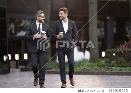 Businessmen go to work. Business talking. Two businessmen in elegant business suit. Walking colleague. Colleague and friends. Two successful business men walking outdoor. Banner 132919455