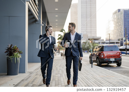 Two CEO businessmen walking and talking in the city. Business men talking. Walking and talking two business men. Colleague walk in New York. Success. Businessmen in suit walking outdoor 132919457