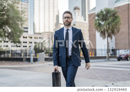 Businessman in suit walk outdoor. Walk to success. Businessman walk in the city. Business man crossing the street. Walk of business man. Businessman in New York. Business success 132919460