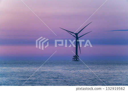 Tranquil sunset over Miaoli coastline with an offshore wind turbine. 132919562