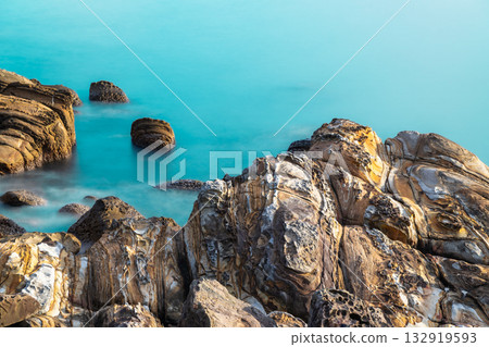 Waves splashing on unique rock formations at Waimushan coastline, Taiwan. 132919593