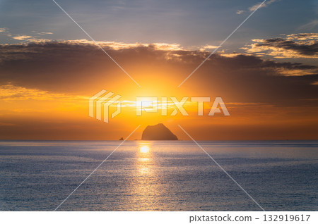 Dramatic Sunrise Behind Keelung Islet Viewed from Waimushan Coast in Taiwan. Dramatic Sunrise Behind Keelung Islet Viewed from Waimushan Coast in Taiwan. 132919617