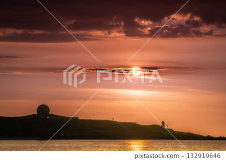 Dreamy Sunset Over Shimen Taiwan with Lighthouse and Moving Clouds. Dreamy Sunset Over Shimen Taiwan with Lighthouse and Moving Clouds. 132919646