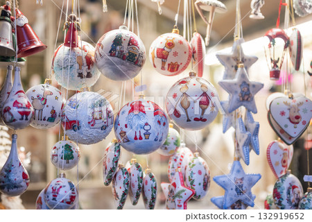 Beautiful Christmas tree decorations and balls are sold in a display case at a Christmas fair Beautiful Christmas tree decorations and balls are sold in a display case at a Christmas fair 132919652