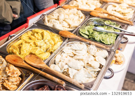 delicious traditional national Polish food pierogi pies at the Christmas fair 132919653