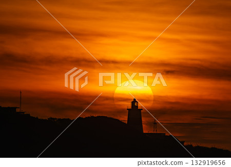 Sunset behind Fuguei Cape Lighthouse in Shimen New Taipei City Taiwan. 132919656