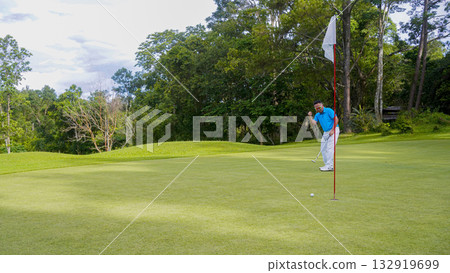 Golfer playing golf in the evening golf course, on sun set evening time. Golfer playing golf in the evening golf course, on sun set evening time. 132919699
