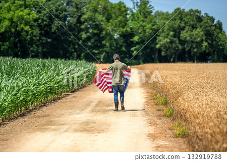 National symbol. Flag of USA. Independence day. Man in field. Man with American flag in crop field. Independence day of America. 4th July. American labor day. American flag and man farmer 132919788