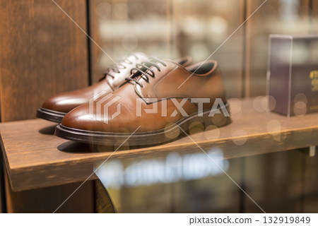 beautiful classic brown stylish men's shoes in the store on display beautiful classic brown stylish men's shoes in the store on display 132919849