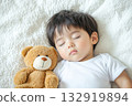 Image of a sleeping baby with a teddy bear. The atmosphere of coziness, safety and calm. The concept of advertising baby products, motherhood, articles about education. Care and well-being of babies 132919894