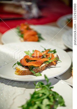 Bruschetta with salmon and arugula Bruschetta with salmon and arugula 132919980