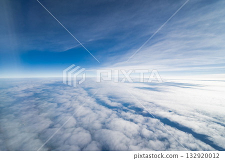 View from an airplane of clouds and a beautiful blue sky 132920012