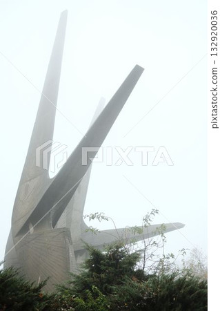 The concrete spires of the Kosmaj Monument emerge through dense morning fog, symbolizing strength and remembrance amid silence 132920036