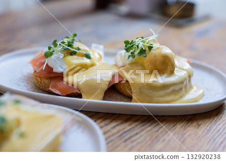 breakfast bruschetta toast with cheese sauce with egg and salmon in a restaurant breakfast bruschetta toast with cheese sauce with egg and salmon in a restaurant 132920238